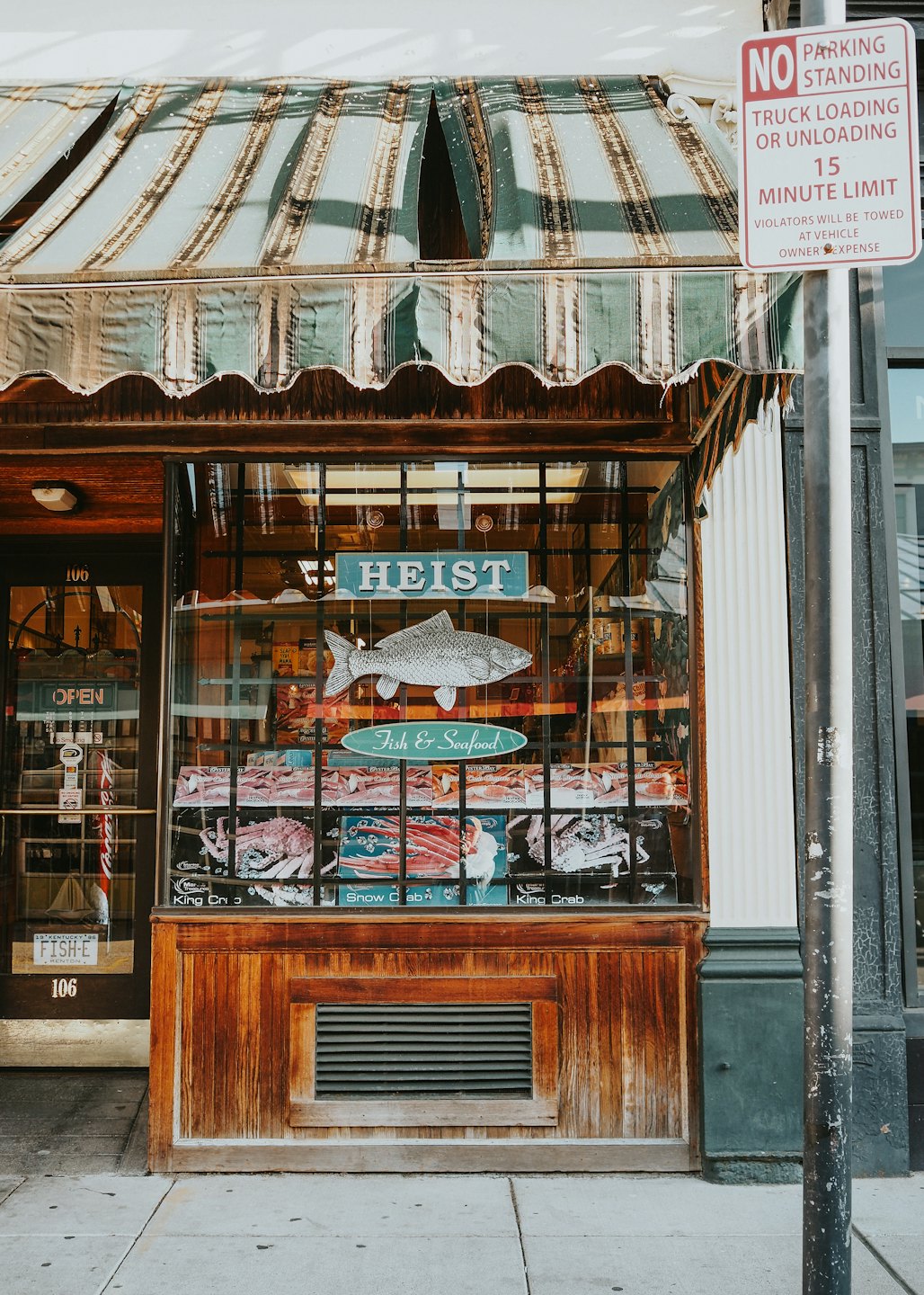 Heist Fish and Seafood market storefront with striped awning.